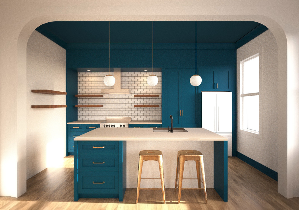 Photo of a small transitional single-wall eat-in kitchen in New York with an undermount sink, shaker cabinets, blue cabinets, solid surface benchtops, white splashback, subway tile splashback, stainless steel appliances, light hardwood floors and with island.
