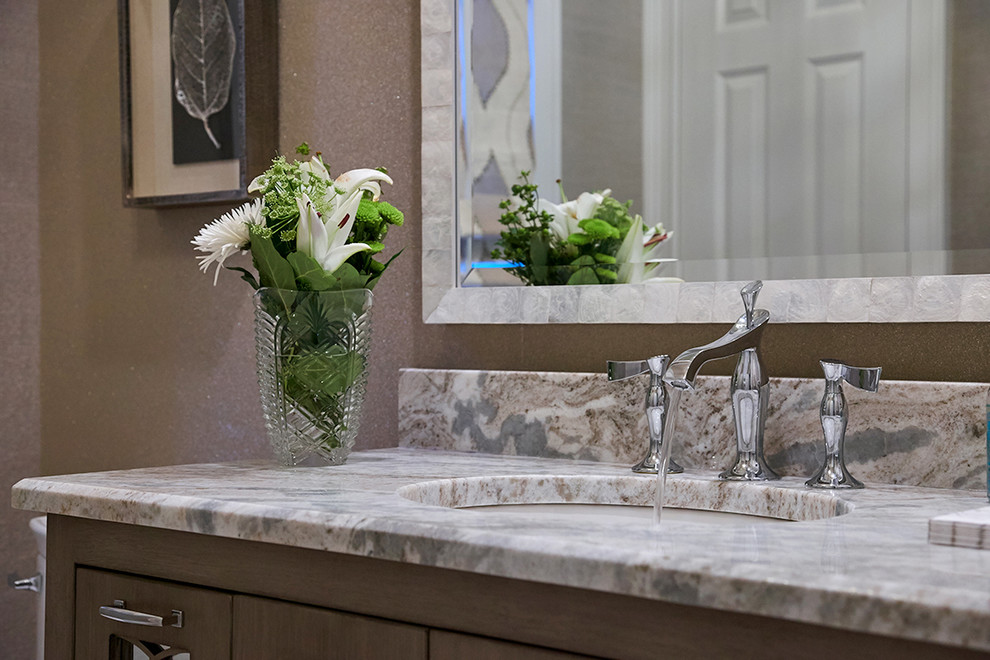 Inspiration for a mid-sized transitional 3/4 beige tile and glass sheet porcelain tile and beige floor bathroom remodel in New York with furniture-like cabinets, light wood cabinets, a one-piece toilet, beige walls, an undermount sink and quartzite countertops