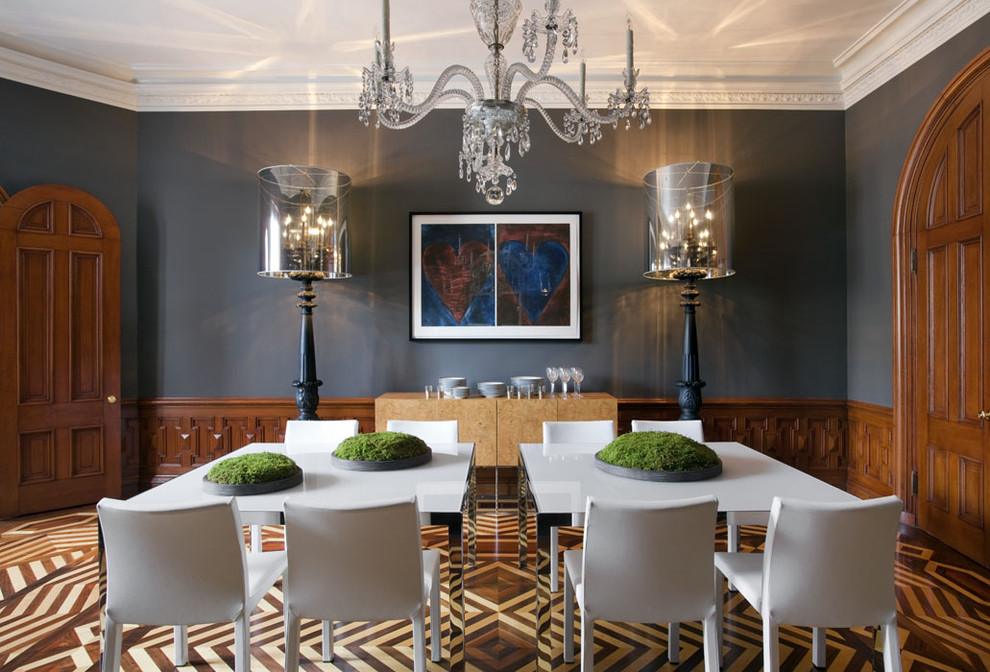 This is an example of an eclectic dining room in Boston with grey walls and decorative wall panelling.