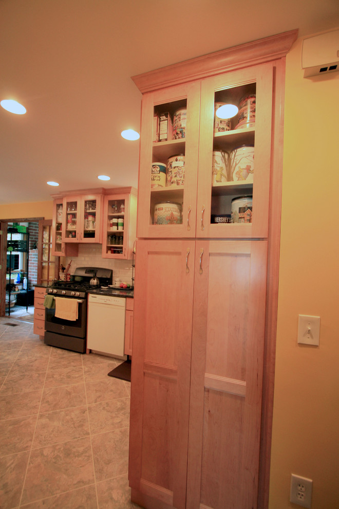 Small transitional eat-in kitchen photo with an undermount sink, recessed-panel cabinets, light wood cabinets, quartz countertops, white backsplash, subway tile backsplash, white appliances and a peninsula