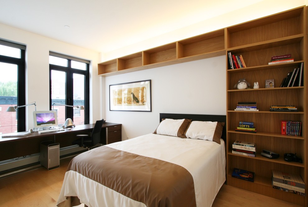 This is an example of a mid-sized contemporary guest bedroom in New York with white walls, light hardwood floors and no fireplace.
