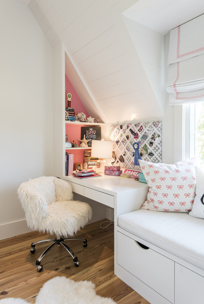 This is an example of a transitional kids' room for girls in Louisville with medium hardwood floors and pink walls.