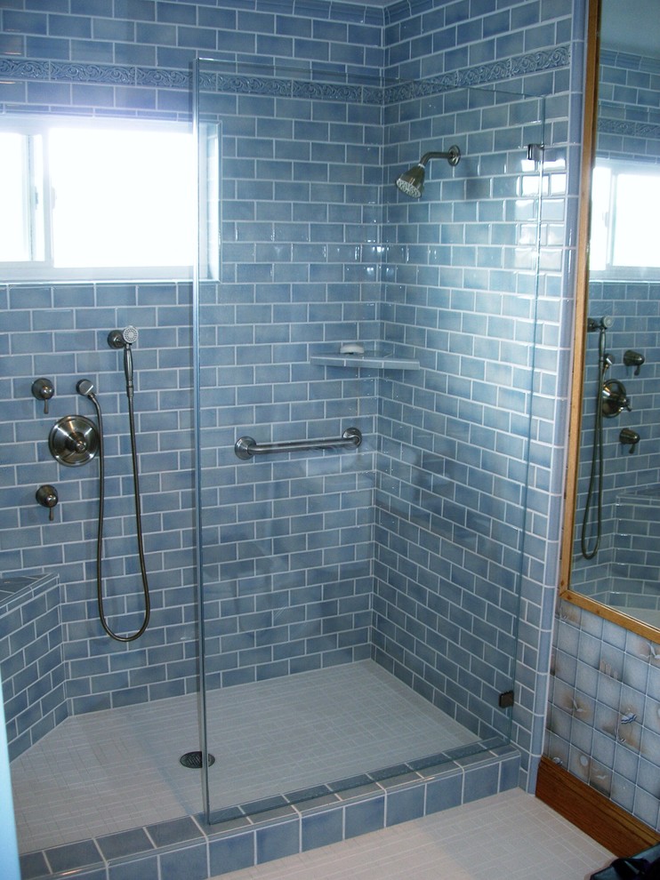 This is an example of a mid-sized contemporary master bathroom in San Francisco with a corner shower, ceramic floors, blue tile, raised-panel cabinets, medium wood cabinets, a one-piece toilet, porcelain tile, blue walls, an undermount sink and granite benchtops.