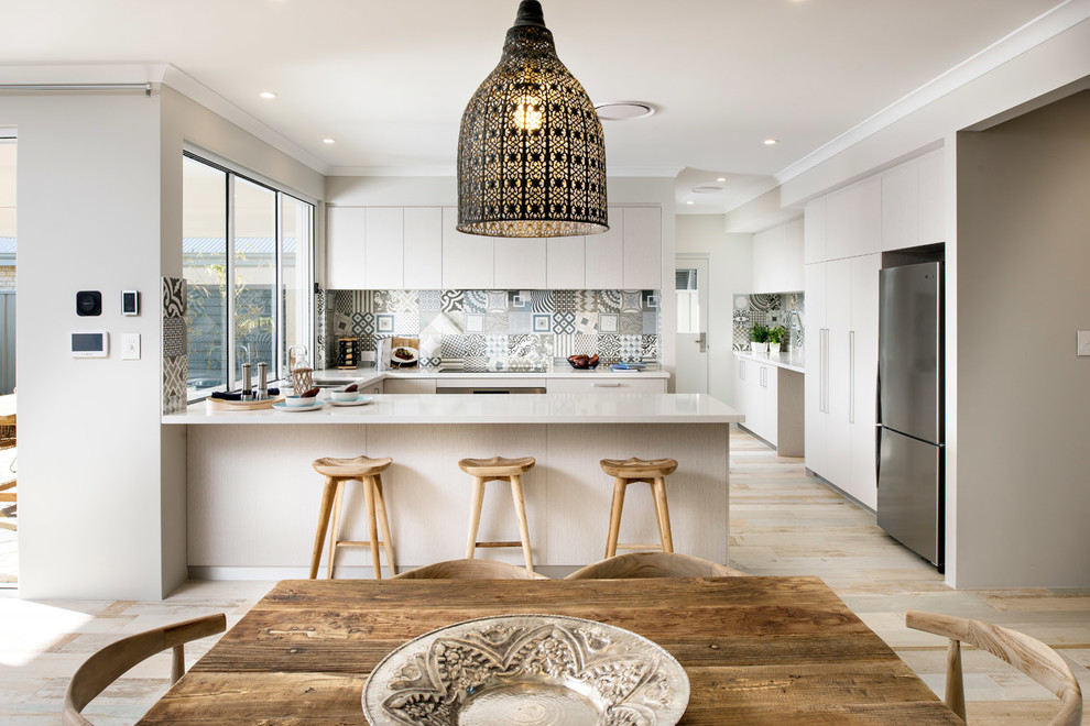 This is an example of a large beach style u-shaped kitchen pantry in Perth with an undermount sink, flat-panel cabinets, light wood cabinets, quartz benchtops, multi-coloured splashback, ceramic splashback, stainless steel appliances, ceramic floors and no island.