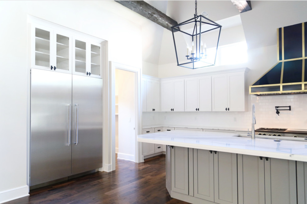 Open concept kitchen - large transitional l-shaped dark wood floor open concept kitchen idea with shaker cabinets, gray cabinets, white backsplash, ceramic backsplash, stainless steel appliances, an island, a double-bowl sink and wood countertops