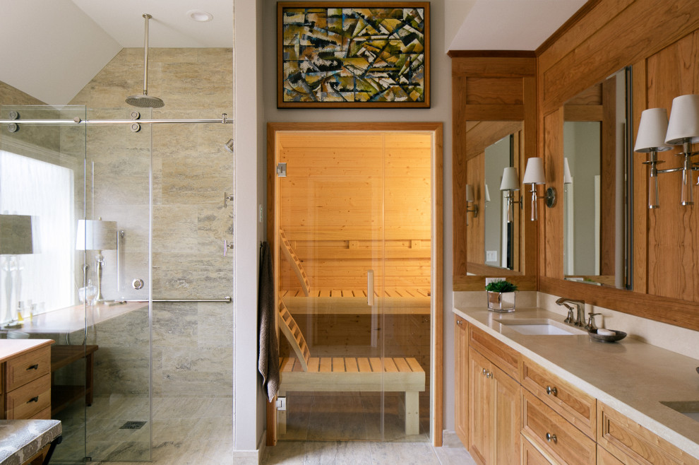 Inspiration för stora klassiska beige en-suite badrum, med luckor med upphöjd panel, bruna skåp, en kantlös dusch, beige kakel, travertinkakel, beige väggar, travertin golv, ett undermonterad handfat, marmorbänkskiva, beiget golv och dusch med skjutdörr