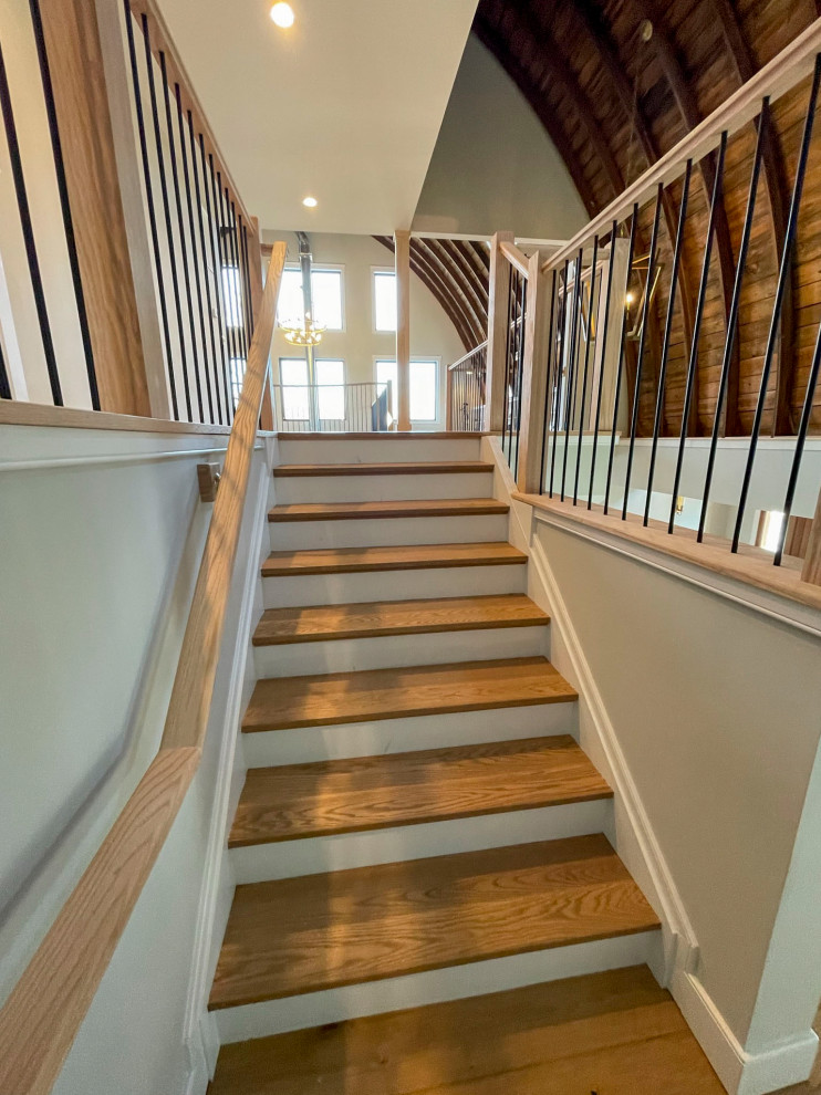 Expansive transitional wood straight staircase in DC Metro with wood risers and mixed railing.