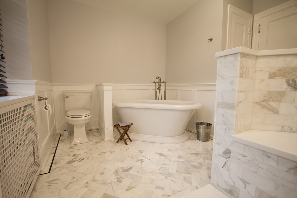 Photo of a mid-sized traditional master bathroom in Philadelphia with grey cabinets, a freestanding tub, an open shower, white tile, subway tile, grey walls, marble floors and engineered quartz benchtops.