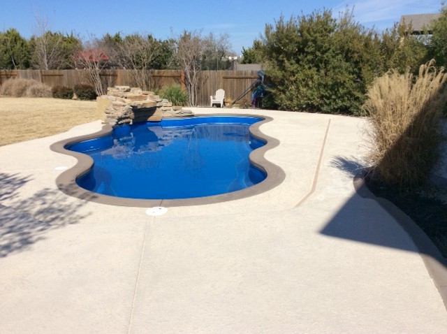 Example of a large minimalist indoor concrete and custom-shaped indoor pool design in Austin