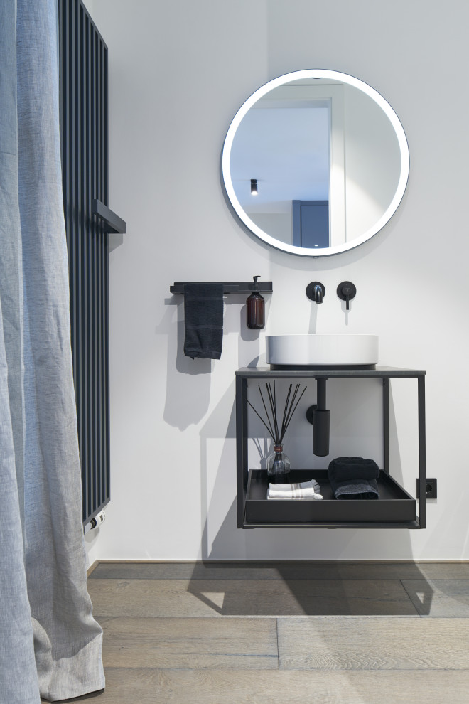 Waschtisch mit rundem Aufsatzbecken und schwarzen Armaturen