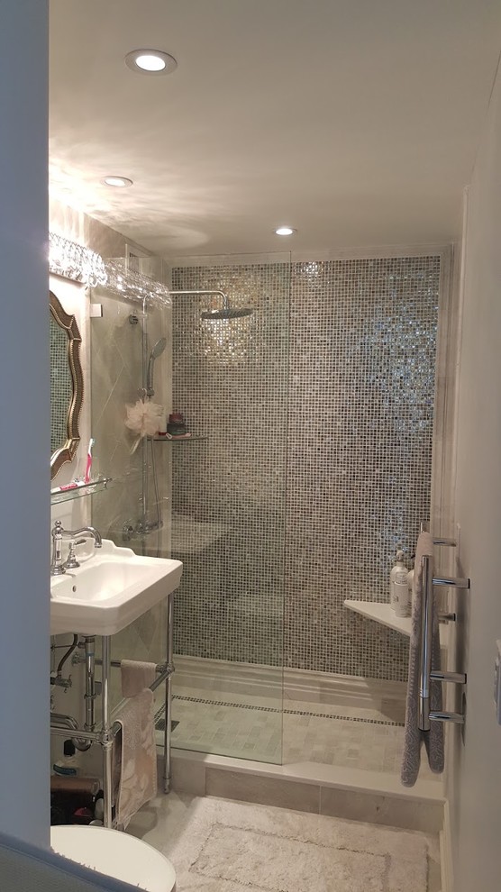 Design ideas for a mid-sized contemporary 3/4 bathroom in Orange County with open cabinets, an open shower, a two-piece toilet, gray tile, multi-coloured tile, white tile, mosaic tile, grey walls, ceramic floors, a wall-mount sink and solid surface benchtops.