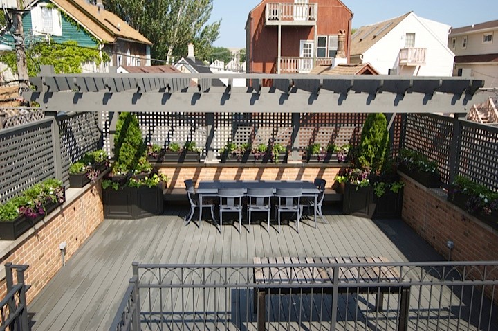 Mid-sized transitional rooftop deck photo in Chicago with a pergola