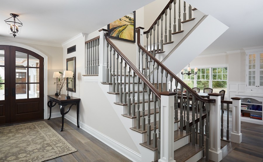 Design ideas for a traditional wood u-shaped staircase with painted wood risers and wood railing.