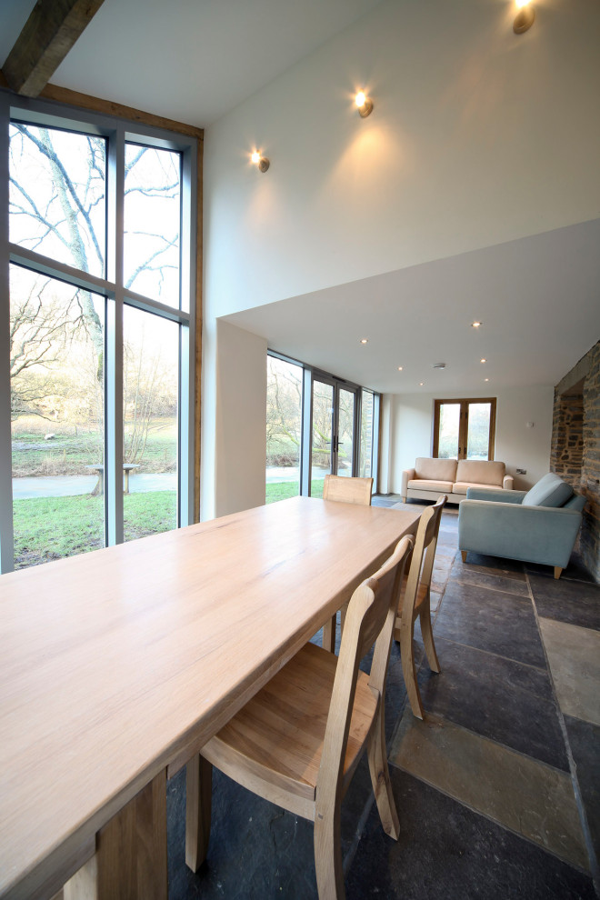 This is an example of a contemporary dining room in Other with slate floors.