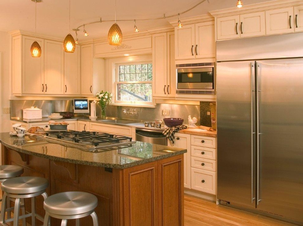 Inspiration for a traditional single-wall eat-in kitchen in Phoenix with white cabinets and stainless steel appliances.
