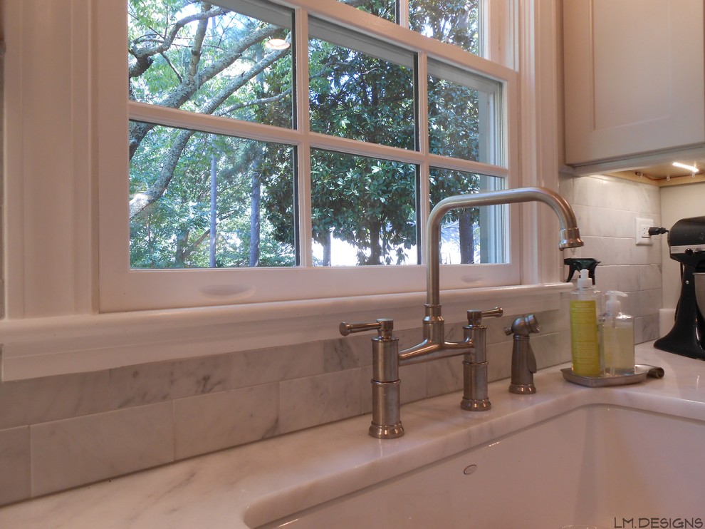 Inspiration for a transitional galley porcelain tile eat-in kitchen remodel with a farmhouse sink, recessed-panel cabinets, gray cabinets, marble countertops, stone tile backsplash and stainless steel appliances