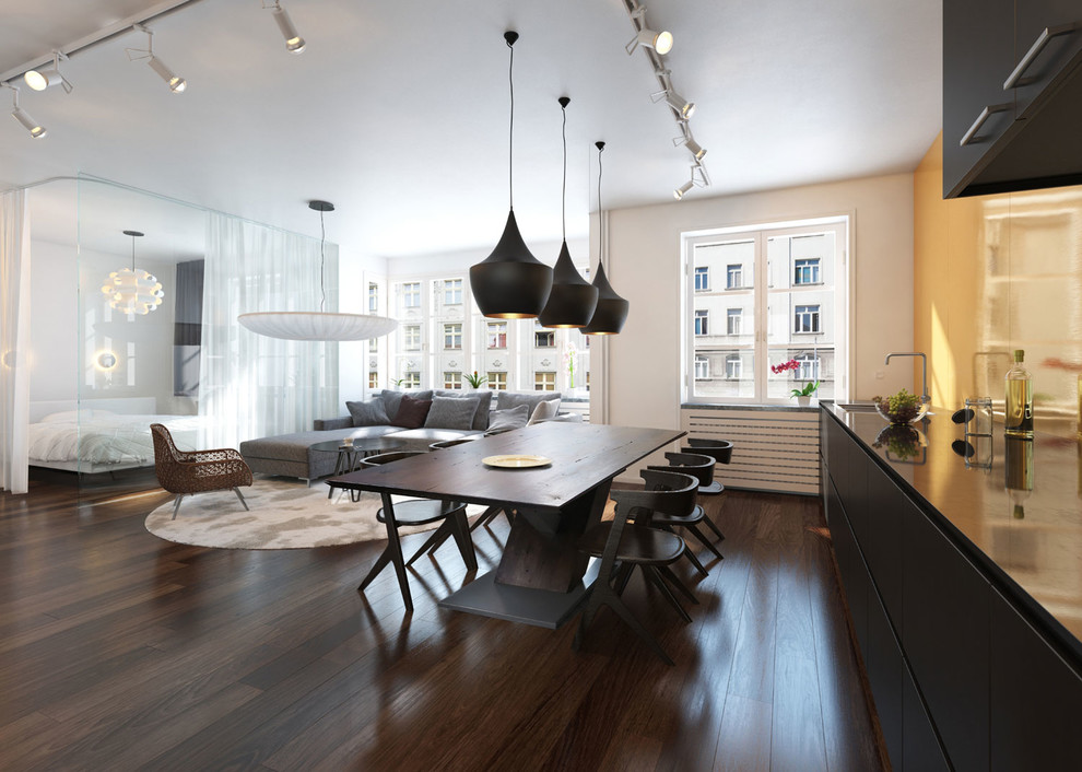 Mid-sized contemporary open plan dining in London with white walls and dark hardwood floors.