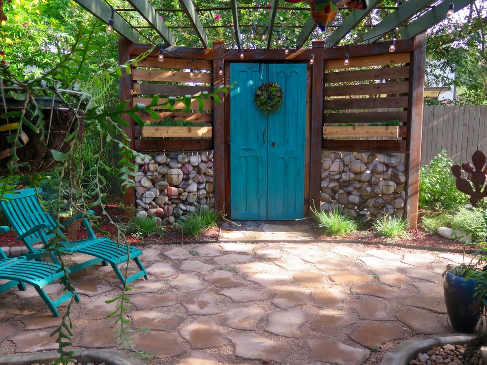 Mid-sized eclectic backyard patio in Other with a container garden, concrete pavers and a pergola.