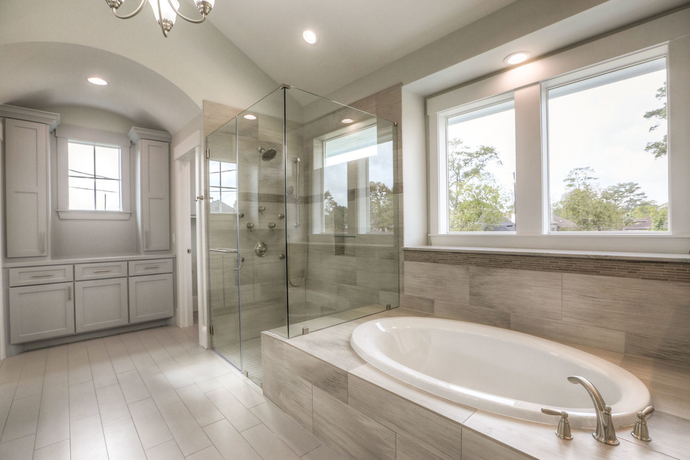 Mid-sized transitional white tile and ceramic tile ceramic tile and gray floor drop-in bathtub photo in Houston with shaker cabinets, white cabinets, a two-piece toilet, white walls, an undermount sink, granite countertops and a hinged shower door