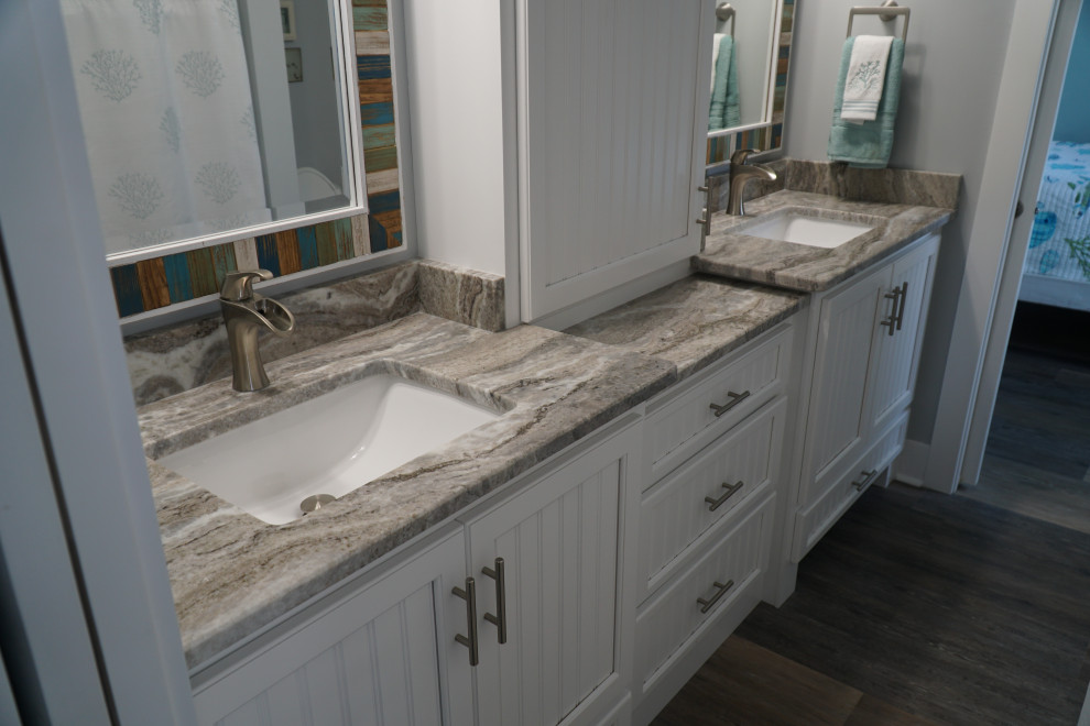 This is an example of a small beach style master bathroom in Other with white cabinets, a drop-in sink, granite benchtops, multi-coloured benchtops, a double vanity and a built-in vanity.