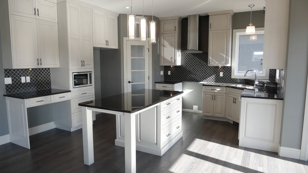 Inspiration for a mid-sized transitional u-shaped open concept kitchen remodel with raised-panel cabinets, white cabinets, granite countertops, black backsplash, ceramic backsplash and an island