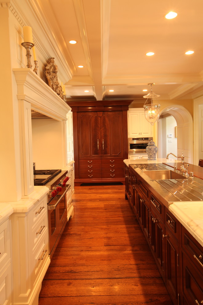 This is an example of a traditional kitchen in Louisville with dark wood cabinets and an integrated sink.