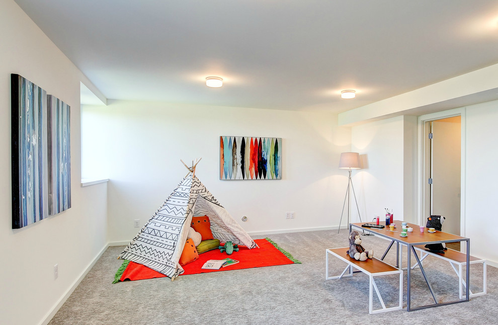 Photo of a large contemporary gender-neutral kids' playroom in Seattle with white walls and carpet.