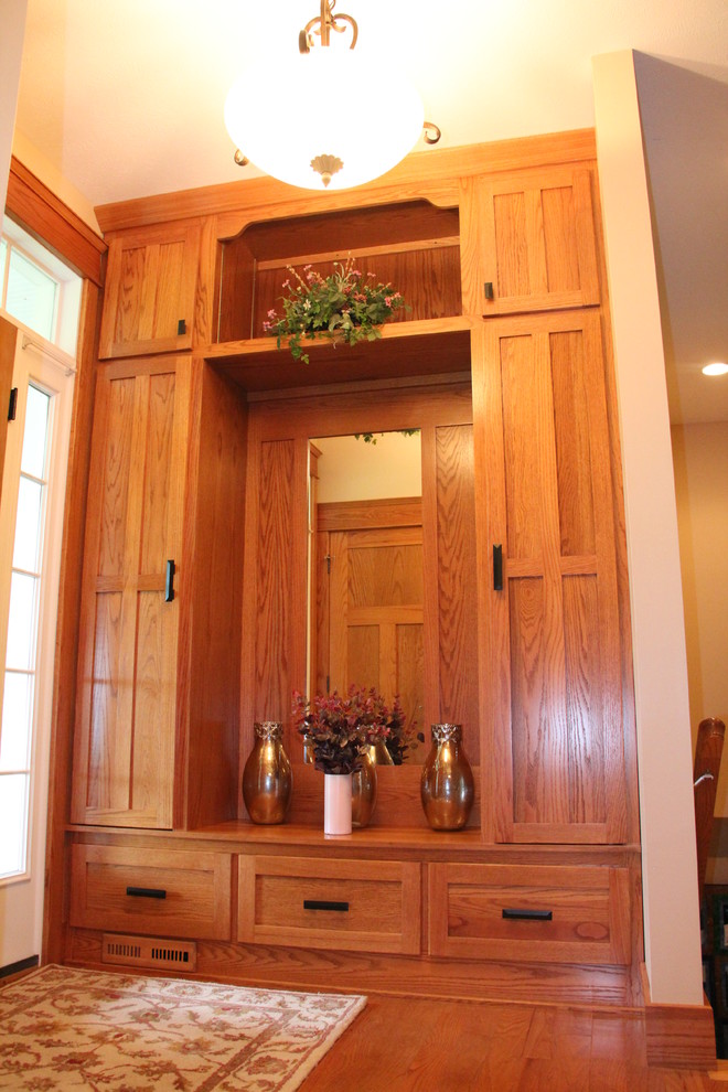 This is an example of an arts and crafts entryway in Chicago with medium hardwood floors.