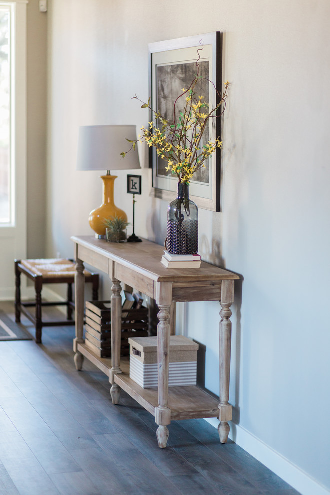 Mid-sized transitional medium tone wood floor foyer photo in Portland with gray walls