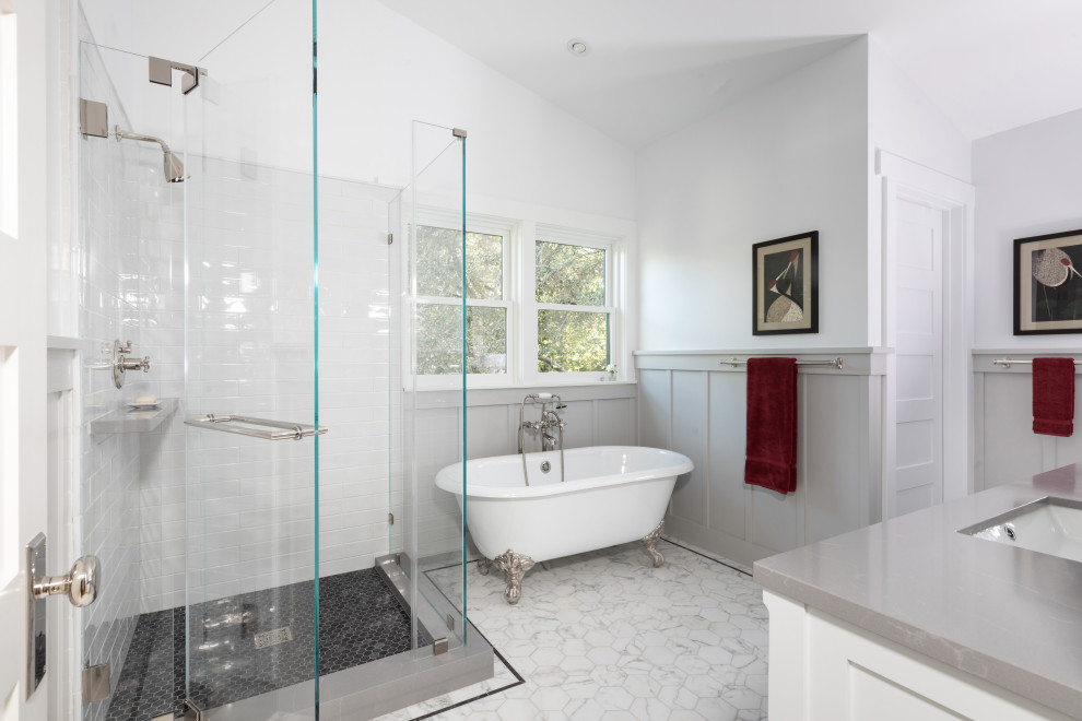 Photo of a large classic bathroom in Los Angeles with white cabinets, a claw-foot bath, a corner shower, white tiles, ceramic tiles, white walls, marble flooring, engineered stone worktops, white floors, a hinged door, grey worktops, an enclosed toilet, a built in vanity unit and wainscoting.