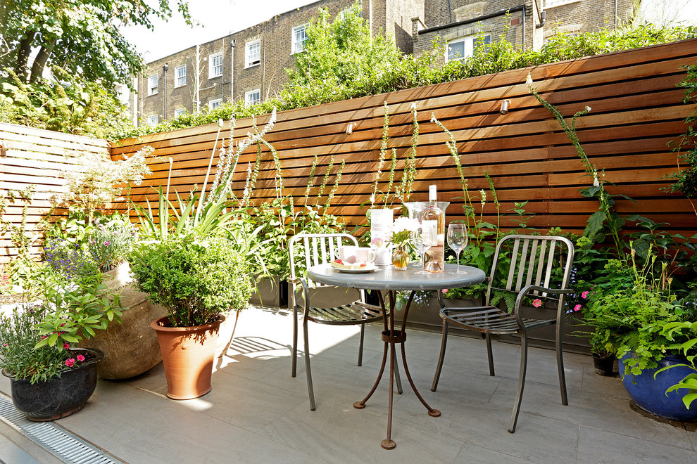 Transitional patio in London with no cover.