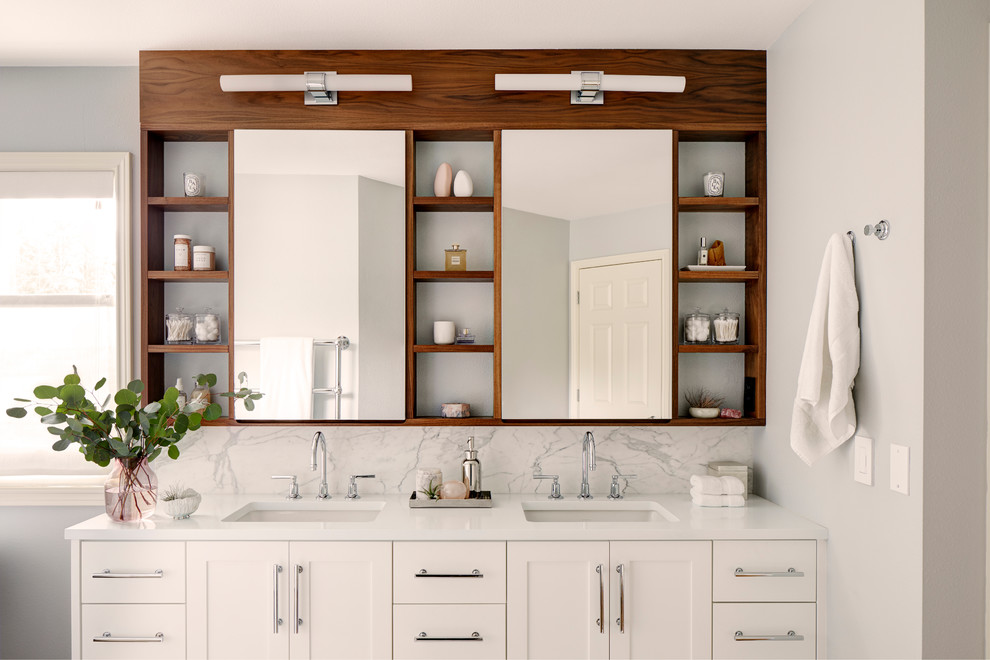 Inspiration for a mid-sized transitional master bathroom in Seattle with shaker cabinets, white cabinets, a freestanding tub, a curbless shower, white tile, marble, white walls, porcelain floors, an undermount sink, quartzite benchtops, brown floor, a hinged shower door and white benchtops.