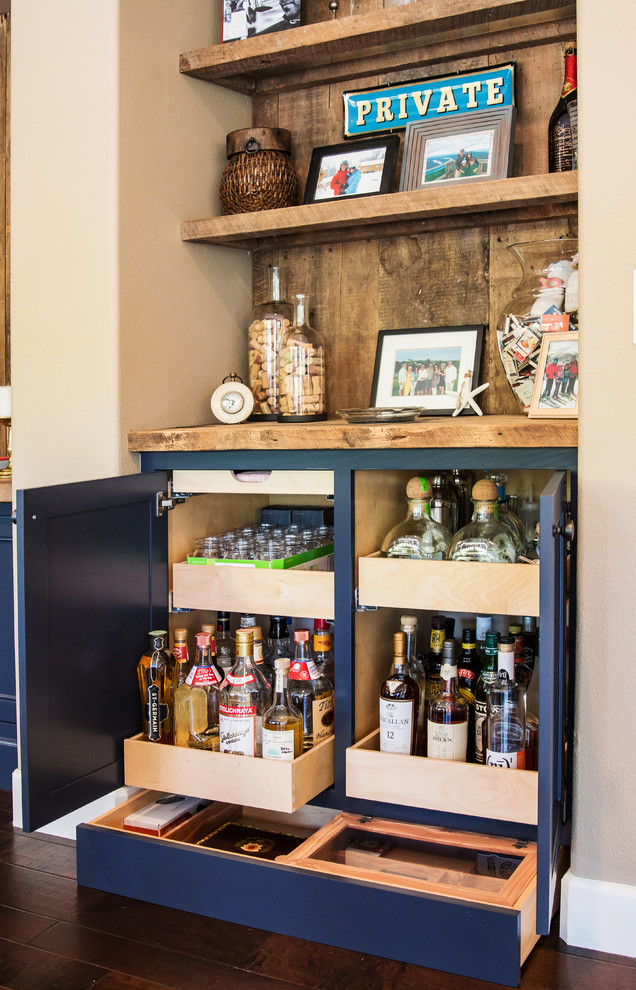 This is an example of a mid-sized traditional single-wall home bar in Orange County with beaded inset cabinets, blue cabinets, wood benchtops, timber splashback and dark hardwood floors.