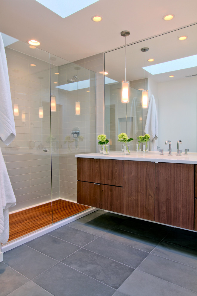 Mid-sized midcentury master bathroom in Indianapolis with flat-panel cabinets, dark wood cabinets, an alcove shower, a two-piece toilet, gray tile, porcelain tile, white walls, slate floors, an undermount sink, engineered quartz benchtops, grey floor and a hinged shower door.