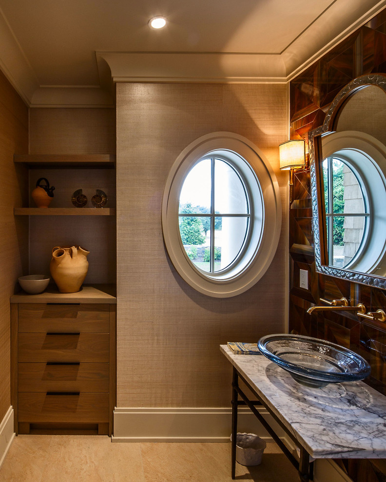 This is an example of a transitional powder room in Boston with a vessel sink, flat-panel cabinets, medium wood cabinets, marble benchtops, brown tile, glass tile and ceramic floors.