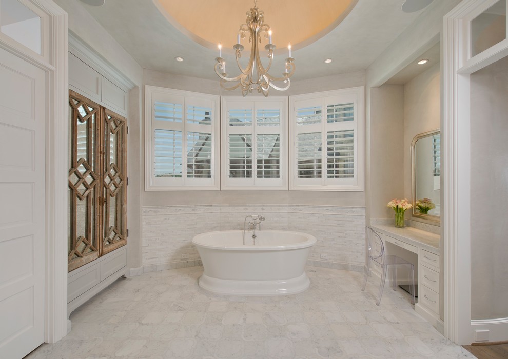 Inspiration for a large country master bathroom in Houston with white cabinets, a freestanding tub, white tile, marble, grey walls, marble floors, marble benchtops and white floor.