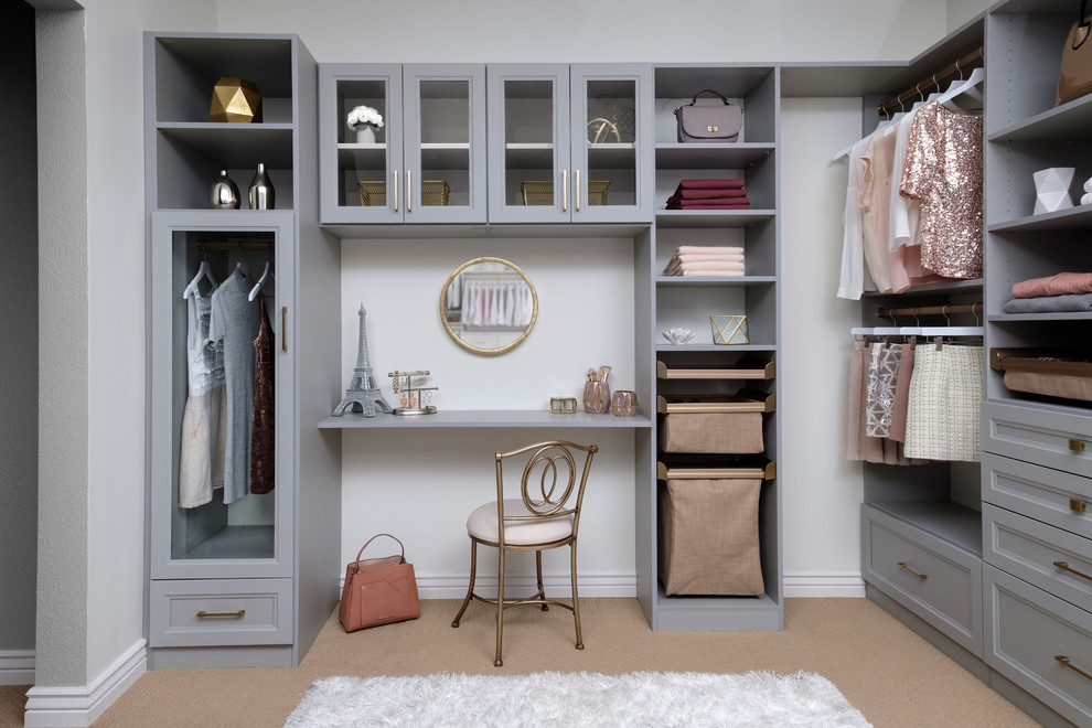 Inspiration for a mid-sized transitional women's walk-in wardrobe in Orange County with shaker cabinets, grey cabinets, carpet and beige floor.