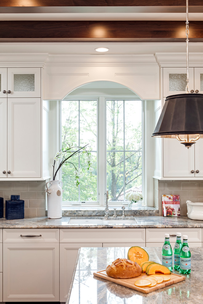 Inspiration for a traditional open plan kitchen in Minneapolis with white cabinets, quartzite benchtops, beige splashback, cement tile splashback, panelled appliances, dark hardwood floors and with island.