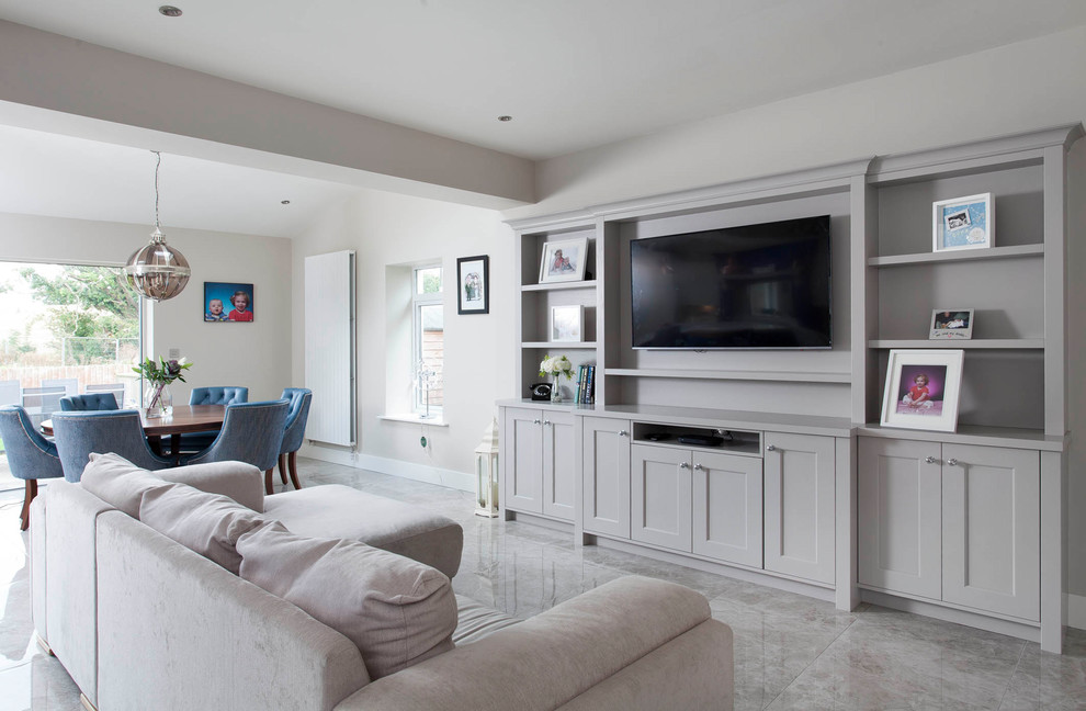 This is an example of an expansive transitional living room in Dublin with ceramic floors.