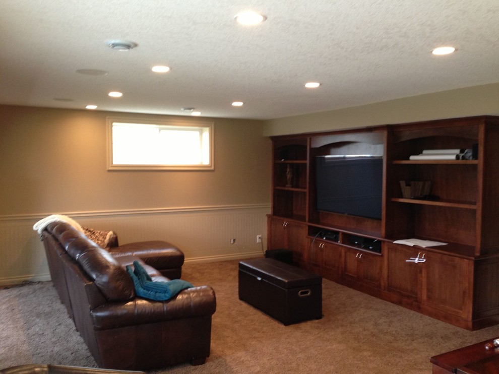 Basement - mid-sized transitional underground carpeted basement idea in Calgary with gray walls