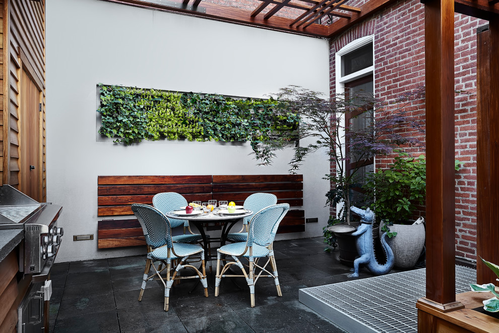 This is an example of a mid-sized asian backyard patio in DC Metro with concrete pavers and a pergola.