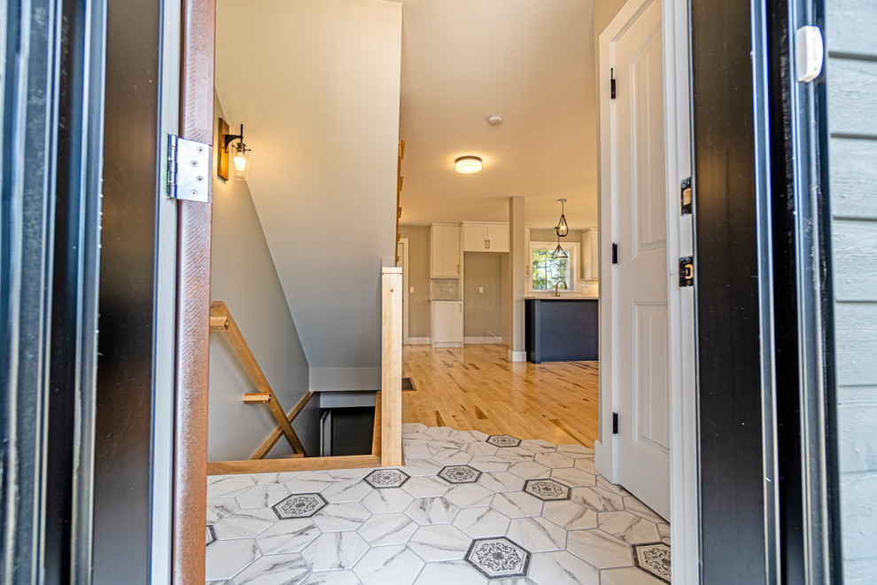 Front door - small transitional ceramic tile and gray floor front door idea with a brown front door