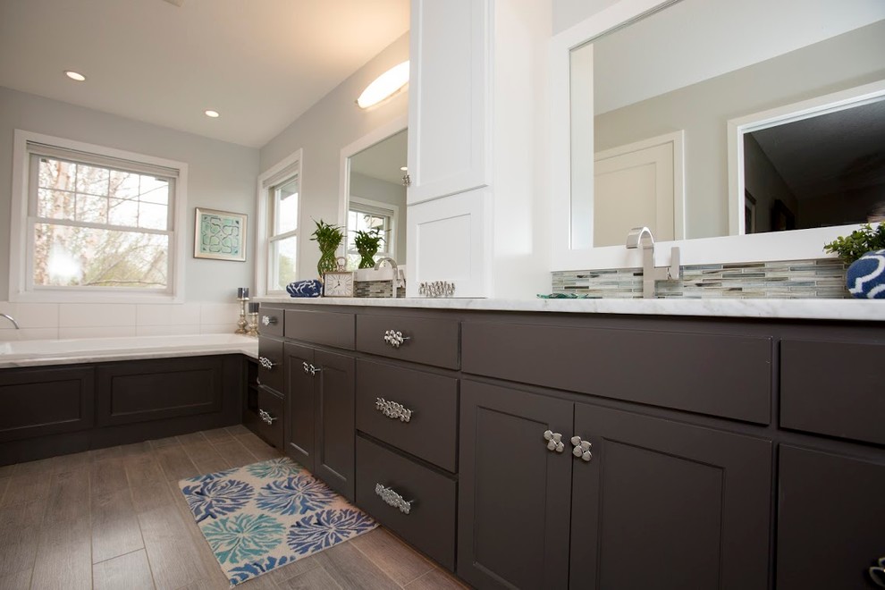 Large contemporary master bathroom in Minneapolis with shaker cabinets, dark wood cabinets, an alcove tub, a corner shower, a one-piece toilet, beige tile, blue tile, gray tile, multi-coloured tile, matchstick tile, grey walls, painted wood floors and an undermount sink.