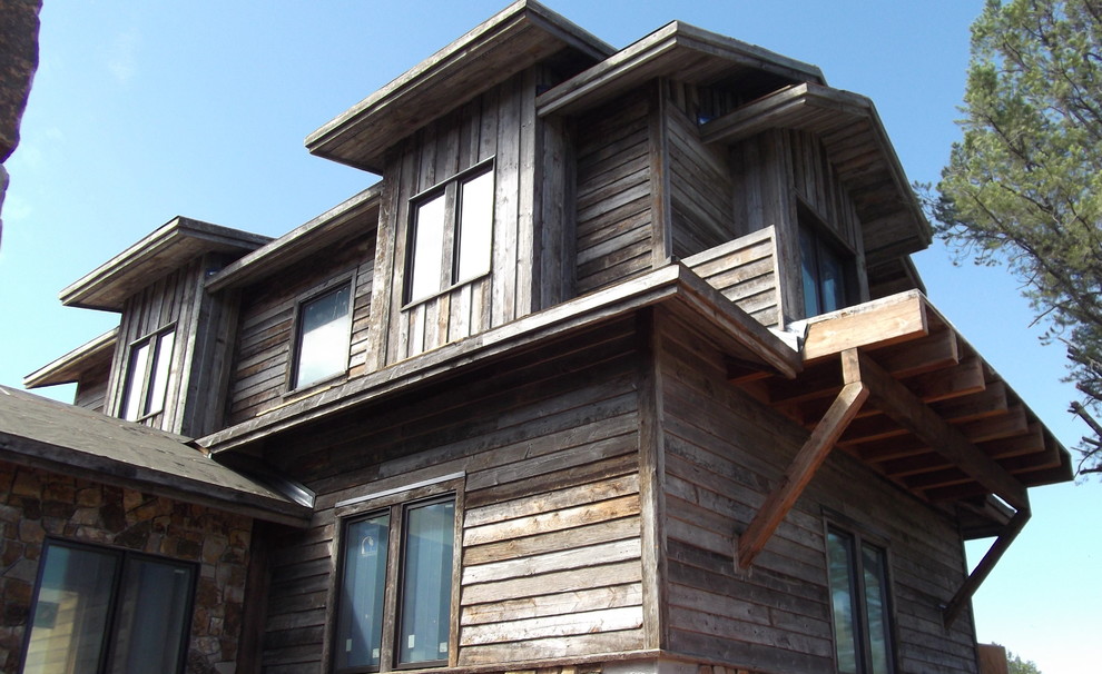 Example of a huge mountain style beige two-story mixed siding gable roof design in Phoenix