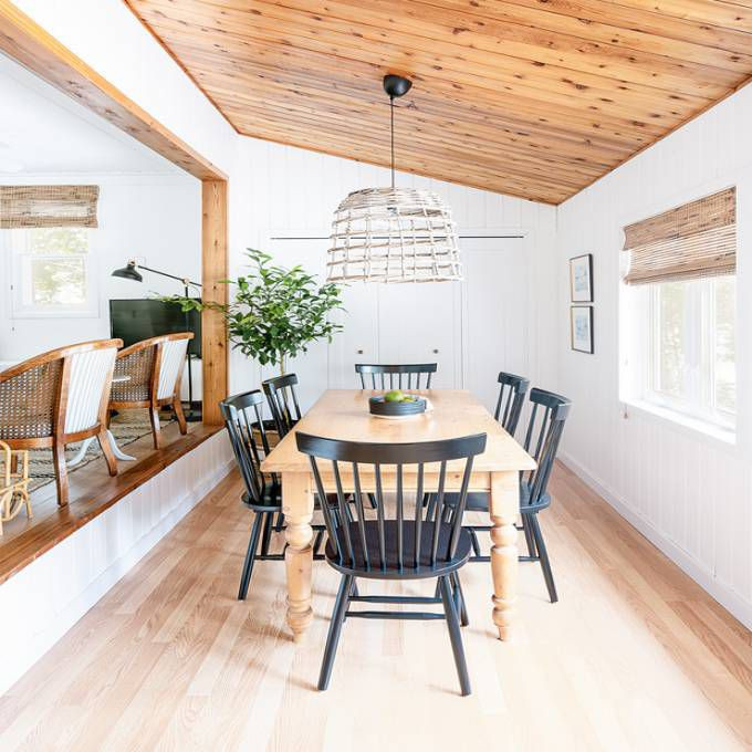 Example of a small beach style light wood floor, beige floor, wood ceiling and wall paneling kitchen/dining room combo design in Toronto with white walls and no fireplace