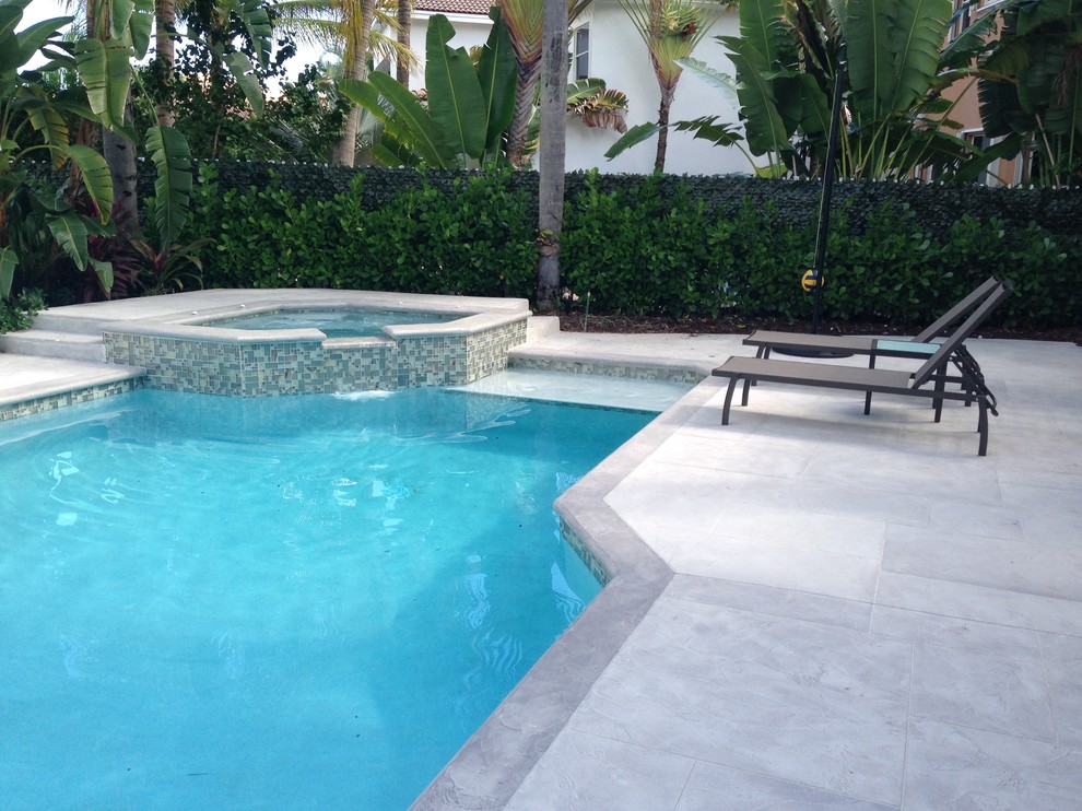 Photo of a mid-sized contemporary backyard patio in Miami with concrete slab.