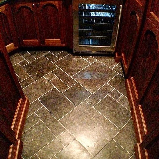 Example of a mid-sized transitional galley porcelain tile enclosed kitchen design in Chicago with a double-bowl sink, raised-panel cabinets, dark wood cabinets, stone tile backsplash, stainless steel appliances and an island