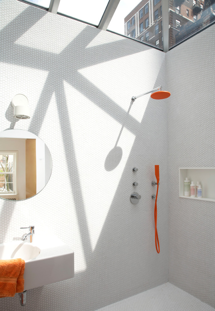 Modern bathroom in New York with a wall-mount sink, white tile, mosaic tile and a curbless shower.