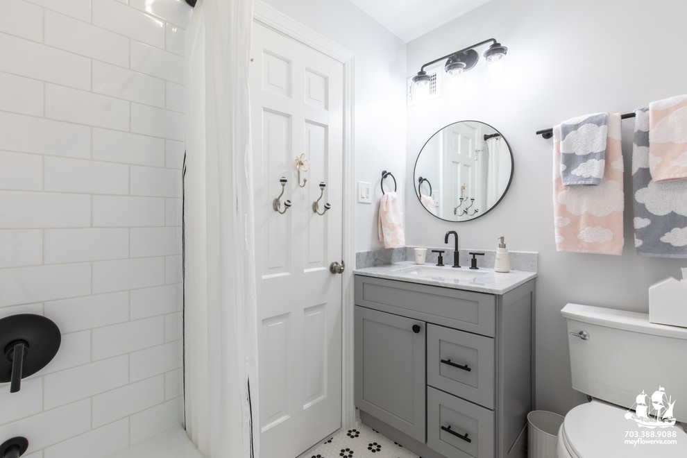 This is an example of a small modern kids bathroom in DC Metro with shaker cabinets, grey cabinets, an alcove tub, a shower/bathtub combo, a two-piece toilet, white tile, subway tile, grey walls, mosaic tile floors, an undermount sink, marble benchtops, white floor, a shower curtain and grey benchtops.