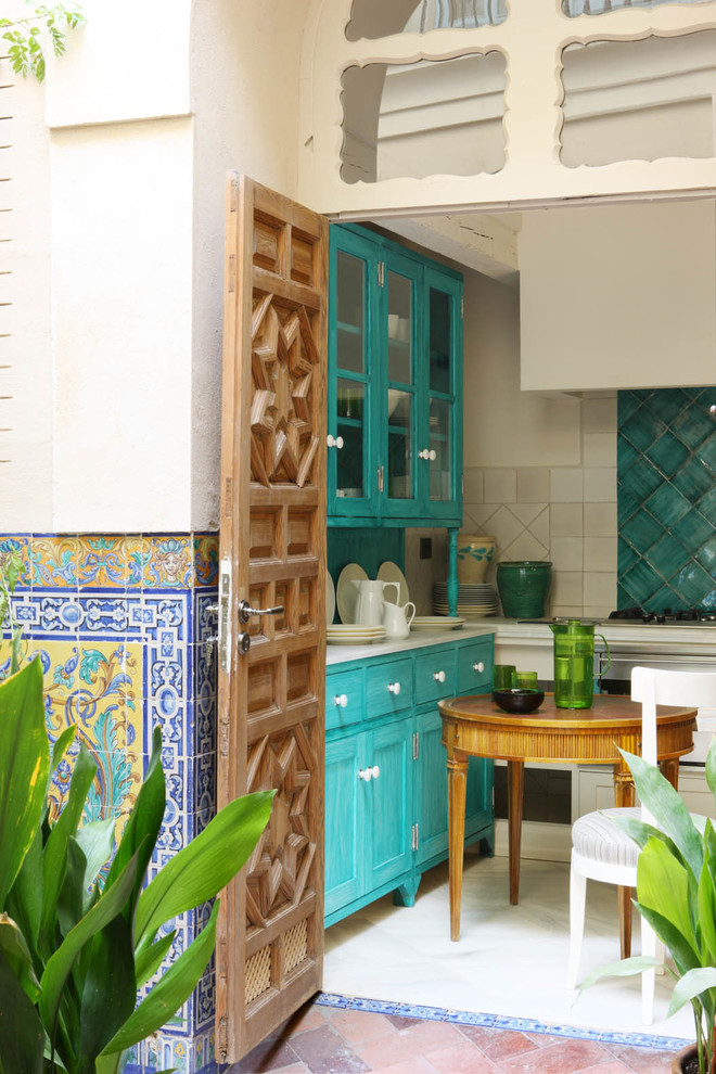 Design ideas for a small mediterranean u-shaped kitchen in Seville with shaker cabinets, blue cabinets, blue splashback, ceramic splashback and no island.